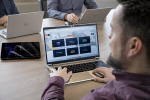 a man sitting at a table using a laptop