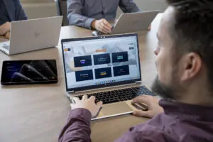 a man sitting at a table using a laptop