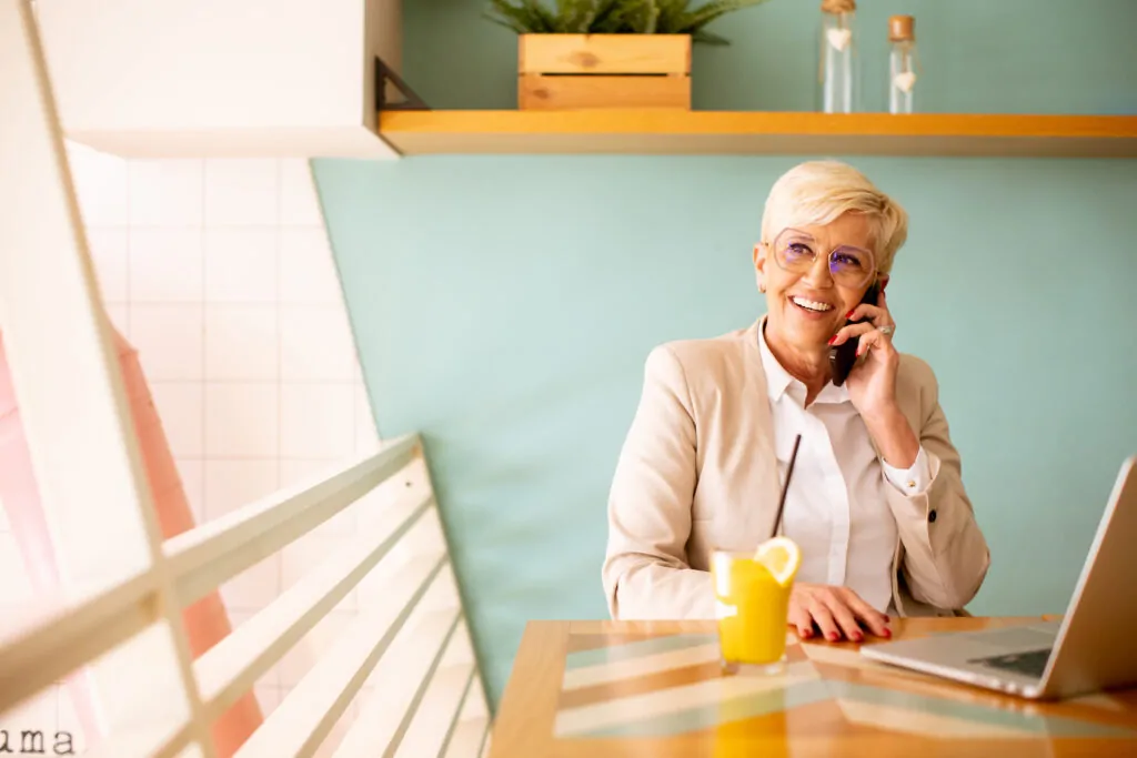 senior woman using mobile phone while working on l 2025 02 21 08 59 44 utc