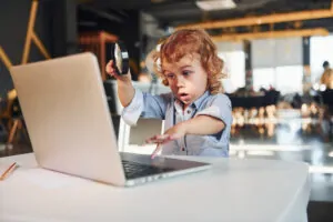 smart child in casual clothes with laptop on table 2023 11 27 05 28 18 utc